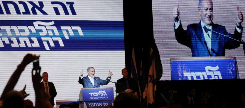 Israeli Prime Minister Netanyahu gestures to supporters at party headquarters in Tel Aviv